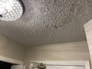 Water damaged popcorn ceiling peeling